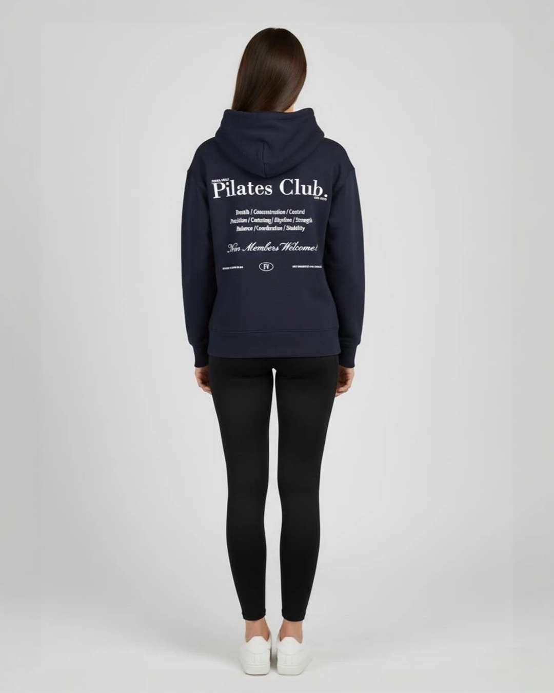Person wearing a navy blue 'Pilates Club' hoodie on a white background