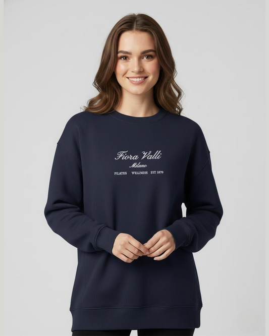 Woman wearing a navy blue sweatshirt with white text on a light gray background