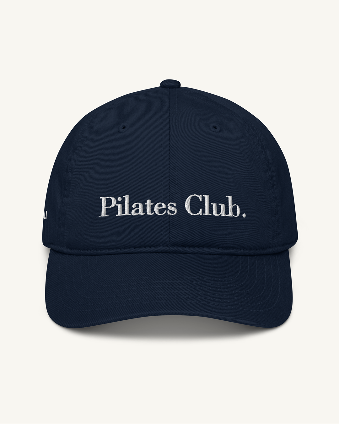 Navy blue cap with 'Pilates Club' text on a white background