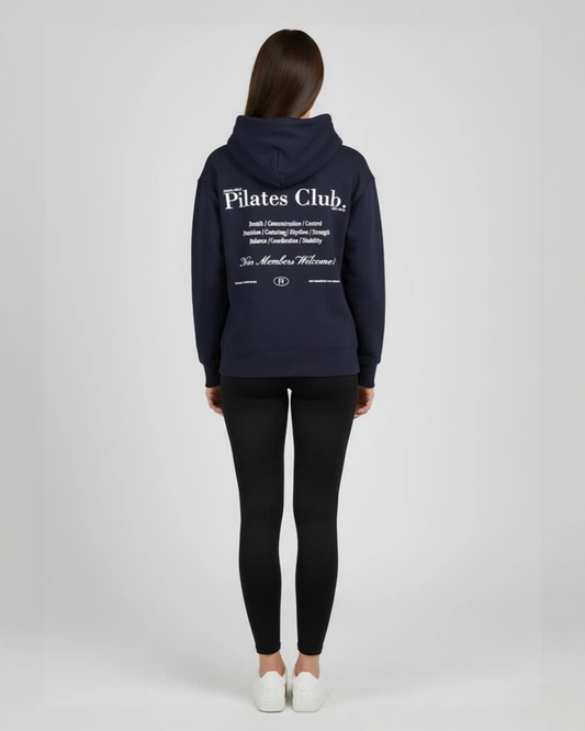 Person wearing a navy blue 'Pilates Club' hoodie on a white background