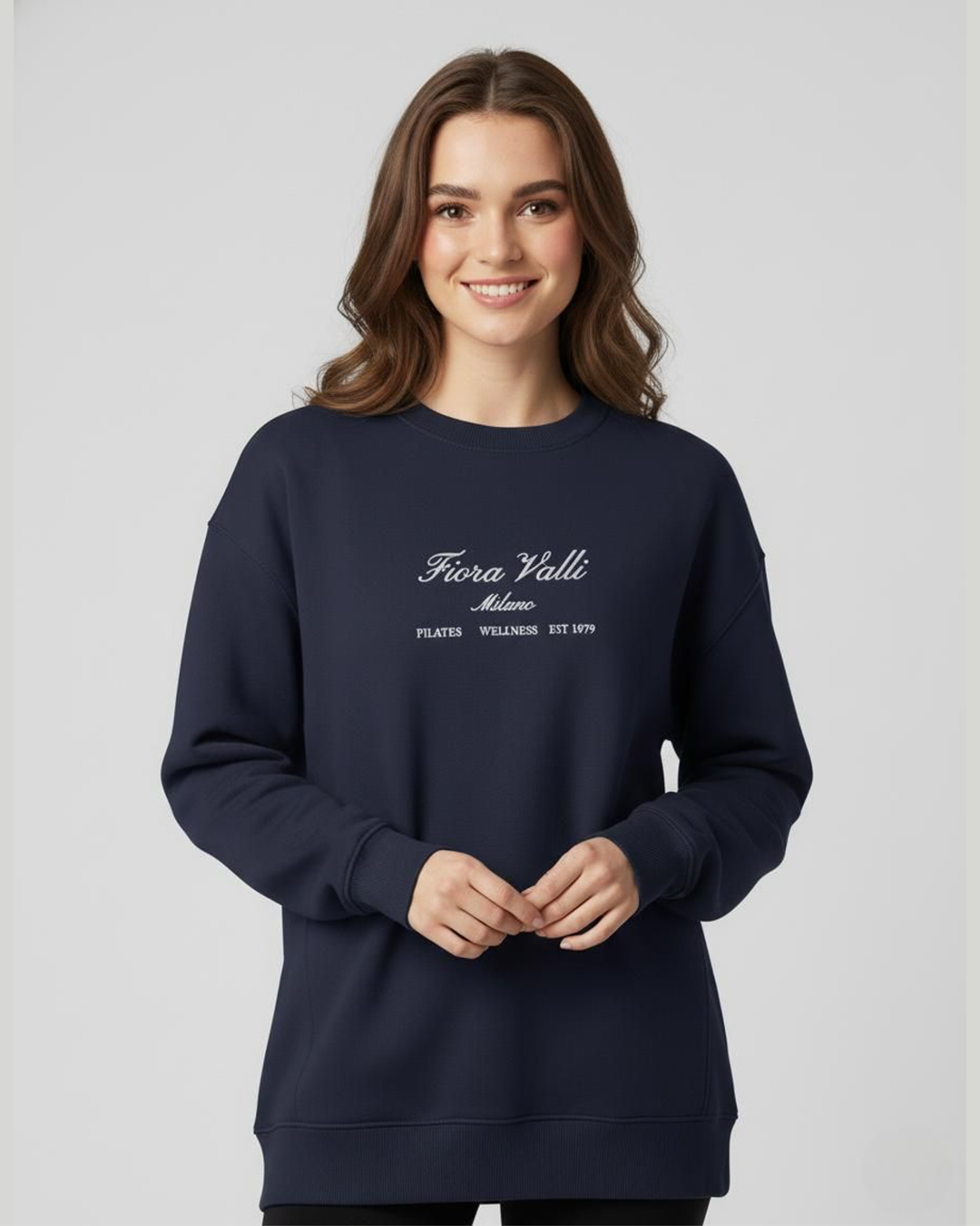 Woman wearing a navy blue sweatshirt with white text on a light gray background