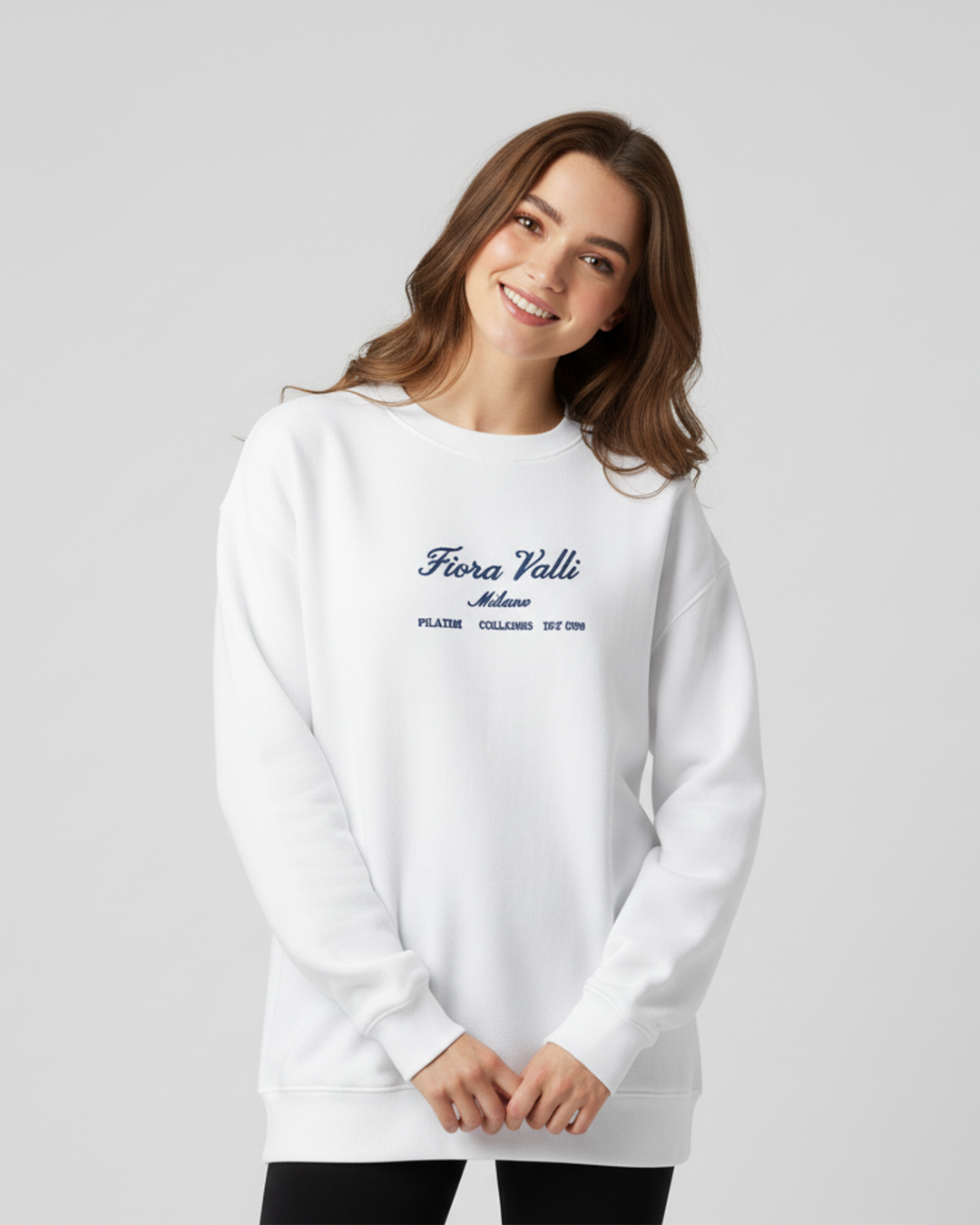 Woman wearing a white sweatshirt with text on a light gray background